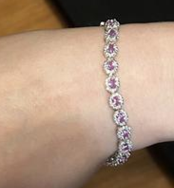 "Absolutely beautiful, amazing quality, and a gorgeous, vibrant pink sapphire! My friend loved it!"	