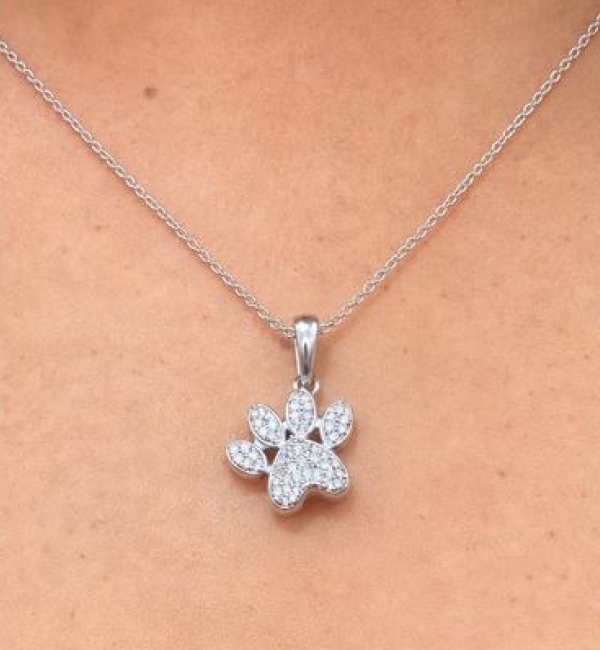 "My husband surprised me with this pendant for our dog’s adoptiversary, celebrating one year since we rescued Bodhi, and I honestly teared up when I opened it. The paw print is elegant, sparkly, and the perfect size."	